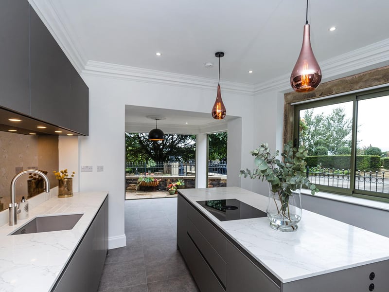 The sleek kitchen with end doorway.