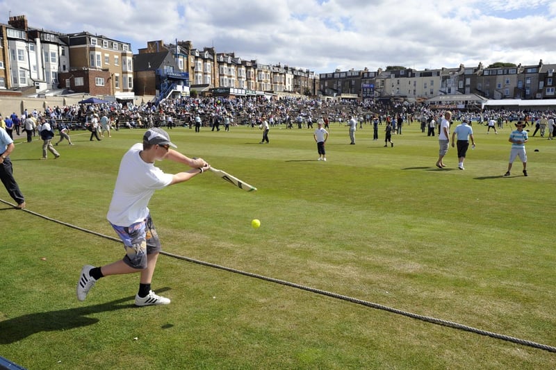 Spectators play cricket during an interval at Scarborough CC