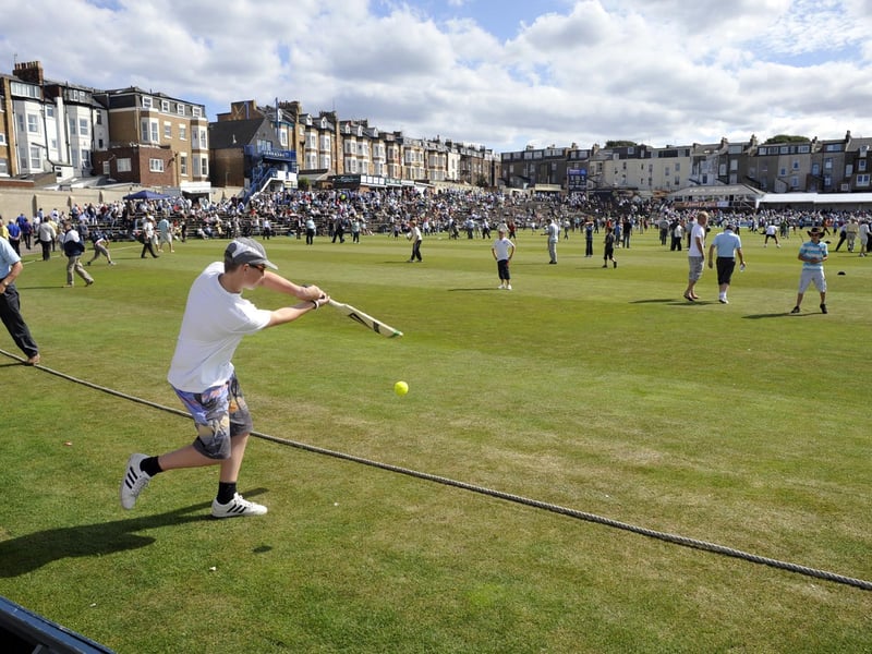 Spectators play cricket during an interval at Scarborough CC