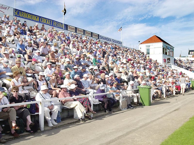 The fans bask in the sun during a Scarborough Cricket Festival match