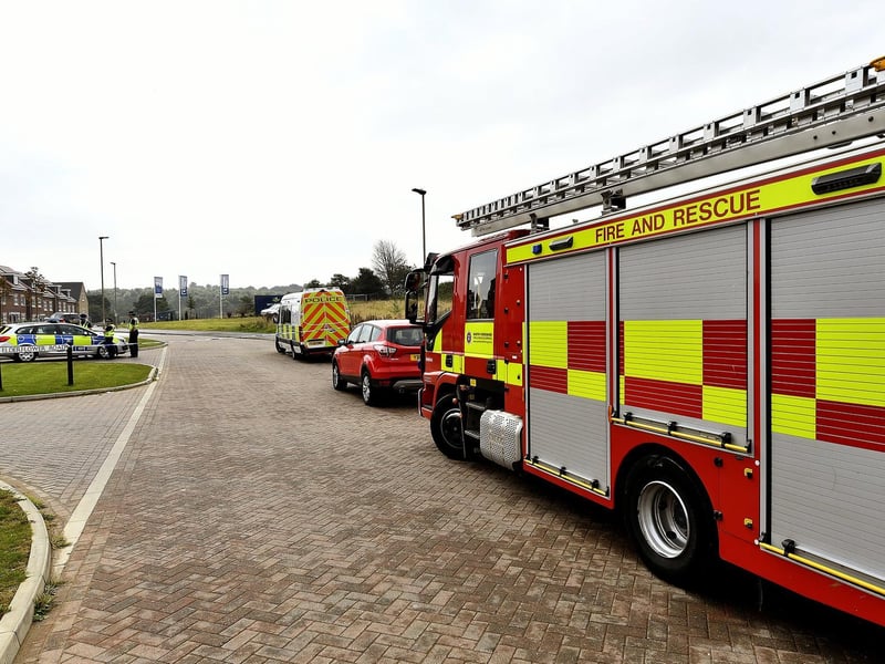 Fire crews and police vehicles at the scene.