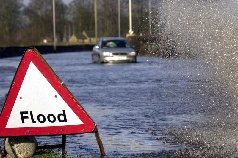 Heavy rain in February 2002 brought flooding chaos to Leeds. A Range Rover drives through flood waters on the A650 at Otley despite the warning signs.