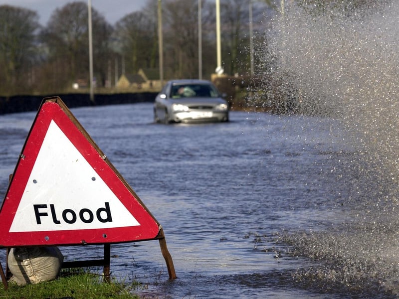 Heavy rain in February 2002 brought flooding chaos to Leeds. A Range Rover drives through flood waters on the A650 at Otley despite the warning signs.