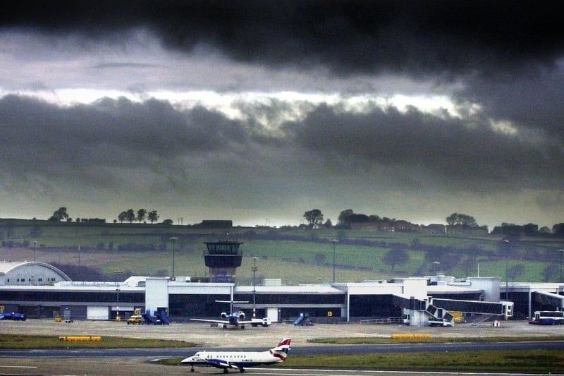 A British Airways plane taxis along the runway as Dark clouds loom over Leeds Bradford Airport in December 2002. BA announced it was cutting flights from the airport.