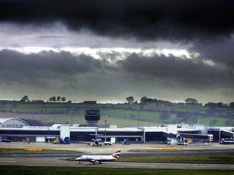 A British Airways plane taxis along the runway as Dark clouds loom over Leeds Bradford Airport in December 2002. BA announced it was cutting flights from the airport.