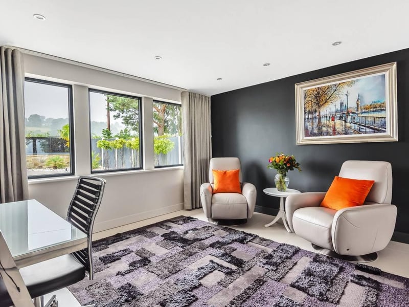 To the front side of this room is a small nook area. The current owners have placed a desk and two armchairs in this space, making it perfect for setting up a laptop and getting some work or studying done, or for sitting in the chairs and relaxing.