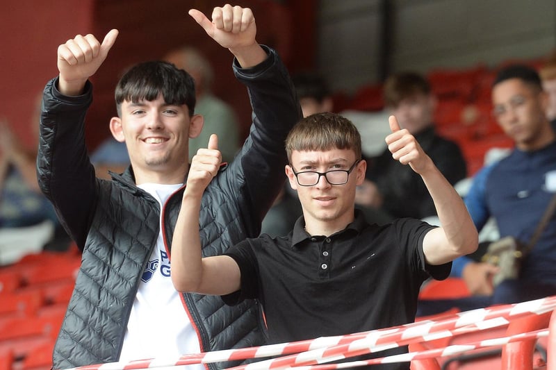 Two Preston fans give the thumbs up at Bristol City