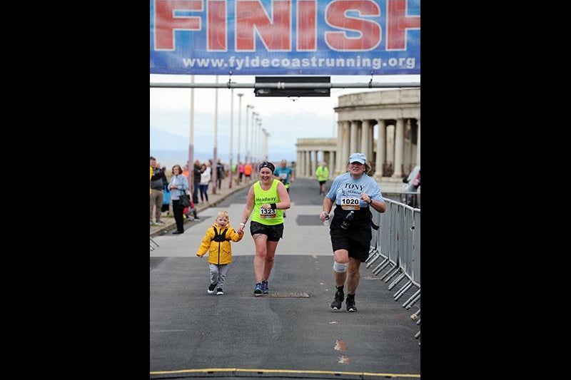 Denise Reynolds crosses the finishing line with her nephew Sydney Ellison from Manchester.