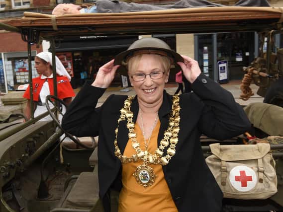 The Mayor of Wigan Coun Yvonne Klieve tries on a tin hat for size, part of the field hospital exhibition at the event.