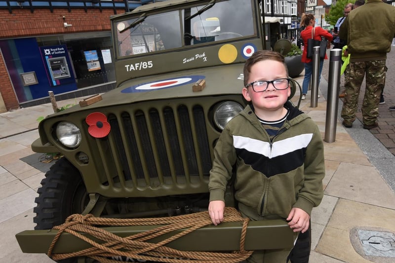 Oliver Richardson-Roden, six, next to one of the vintage vehicles as part of the event.