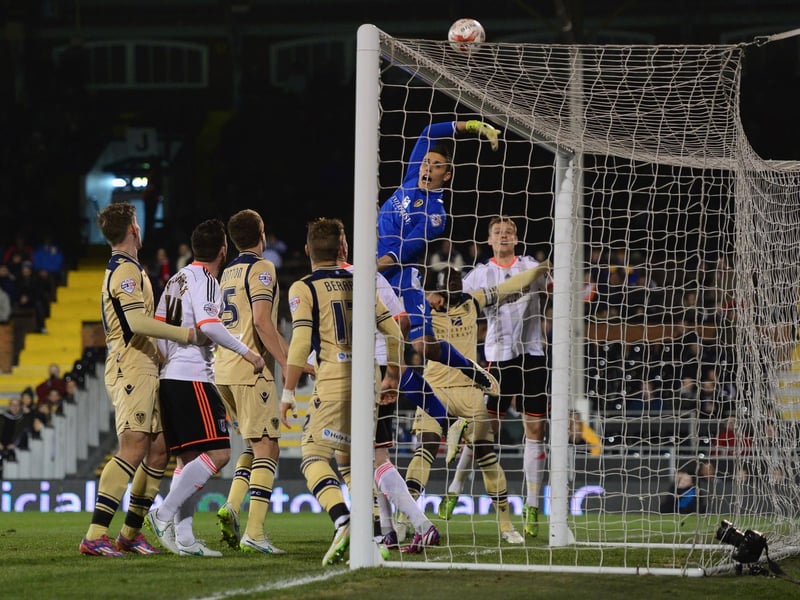 Leeds United goalkeeper Marco Silvestri stretches for a cross.