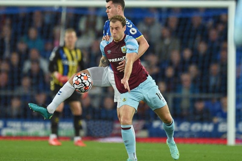 Michael Keane and Ashley Barnes tussle for the ball.