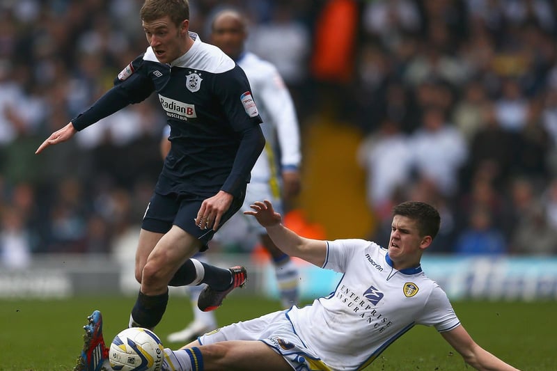 Sam Byram tackles Huddersfield Town's Paul Dixon during the Championship clash at Elland Road in March 2013.