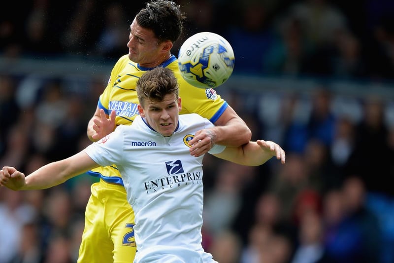 Sam Byram rises high with Sheffield Wednesday's Gary Madine during the  Championship clash at Elland Road in October 2014.