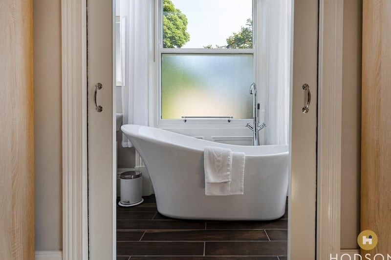 A deep slipper bath within one of the bathrooms.