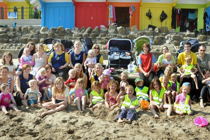 Buttercups Nursery took to the beach on the last day of the school holidays. 
Children, helpers and parents pictured on the beach in front of the beach huts.