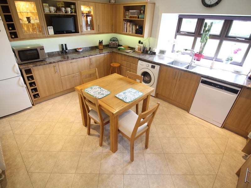 A bright and roomy kitchen with fitted units.