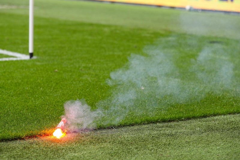 A pyrotechnic is thrown onto the pitch