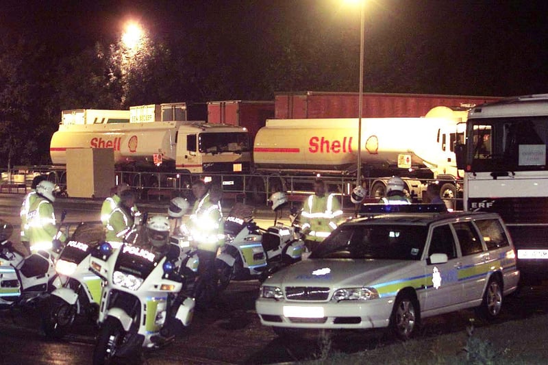 A convoy of tankers with a heavy police presence wait at an unnamed service station on the M62 near Leeds waiting to fill up the public filling station.