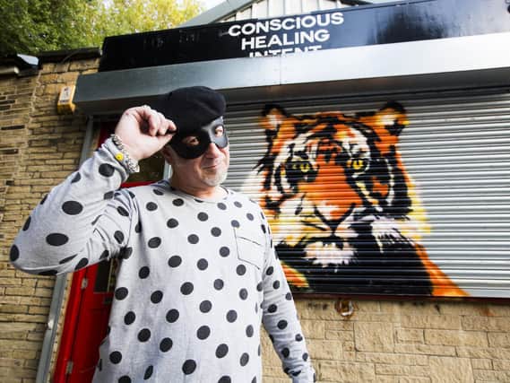 Artist Trafford Parsons with Tiger, one of his shop shutter murals in Dewsbury town centre