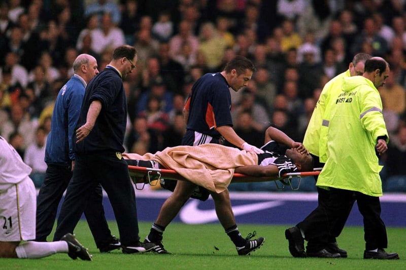 Tottenham Hotspur striker Les Ferdinand is stretchered off during the game.