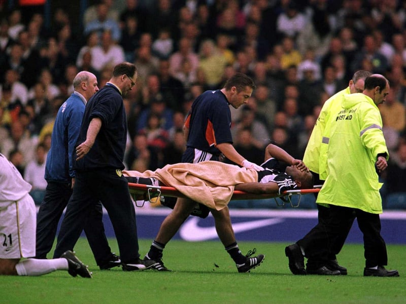 Tottenham Hotspur striker Les Ferdinand is stretchered off during the game.