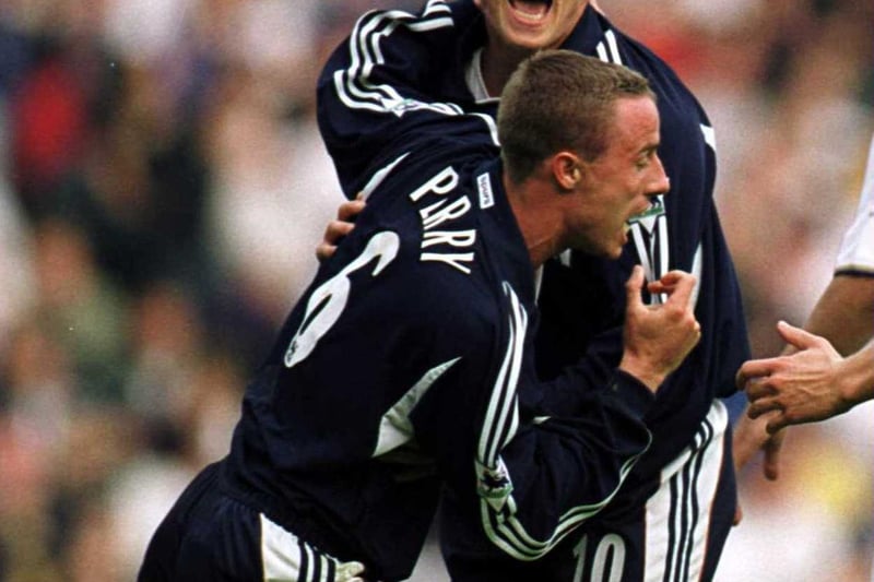 Chris Perry celebrates with teammate Steffen Iverson after scoring Tottenham Hotspur's second goal.