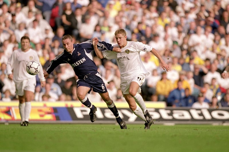 Striker Alan Smith Perry tussles with Tottenham Hotspur's Chris Perry.