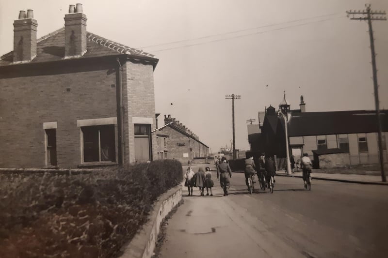 Families and people on bikes, possibly on their way to work at ICI, are photographed here in Burn Naze