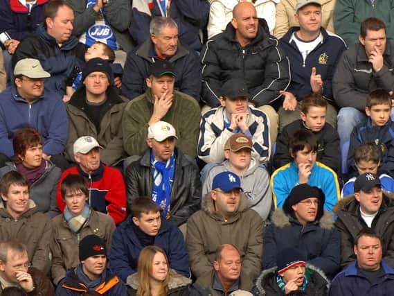 Fans watch Wigan Athletic v Arsenal in November 2005