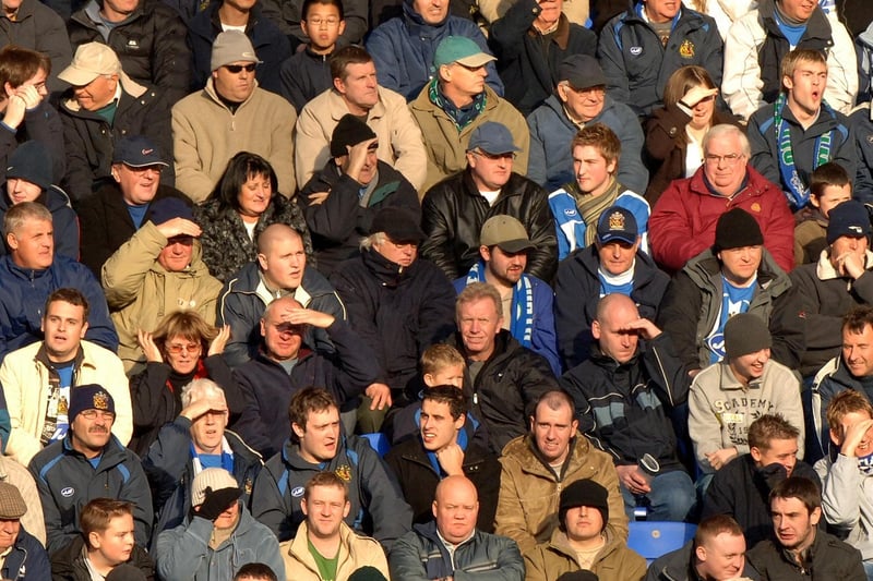 Fans watch Wigan v Arsenal in November 2005
