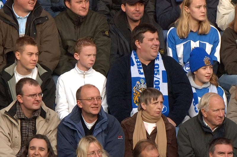 Fans watch Wigan Athletic v Arsenal in November 2005