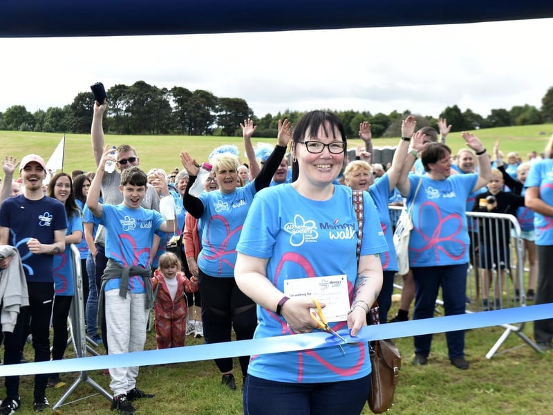 Debbie Skenfield cuts the ribbon to start the walk