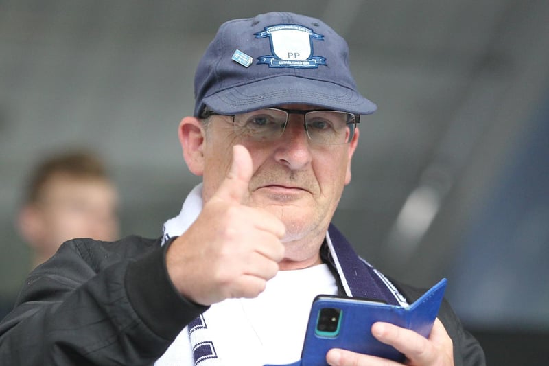 This North End fan gives the thumbs up as he looks up from his phone