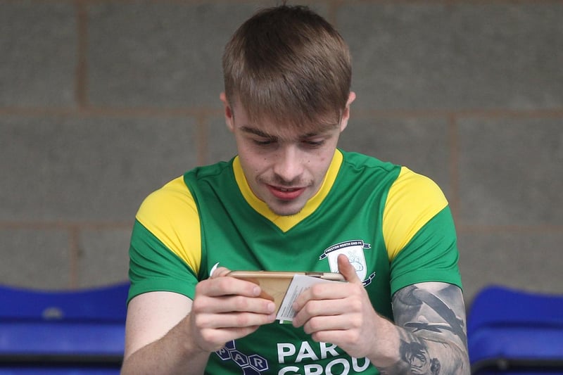A PNE fan checks his phone ahead of the Birmingham game