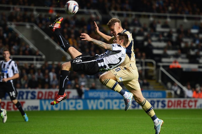 Newcastle United's Mathieu Debuchy clears the ball from Matt Smith during the Capital One Cup third round clash at St James' Park in September 2013.