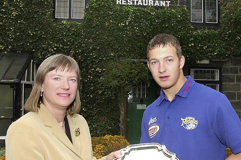 Anne Scott , owner of Bretts fish and chip restaurant in Headingley, presents Leeds Rhinos academy player Danny McGuire with his Player of the Year trophy.