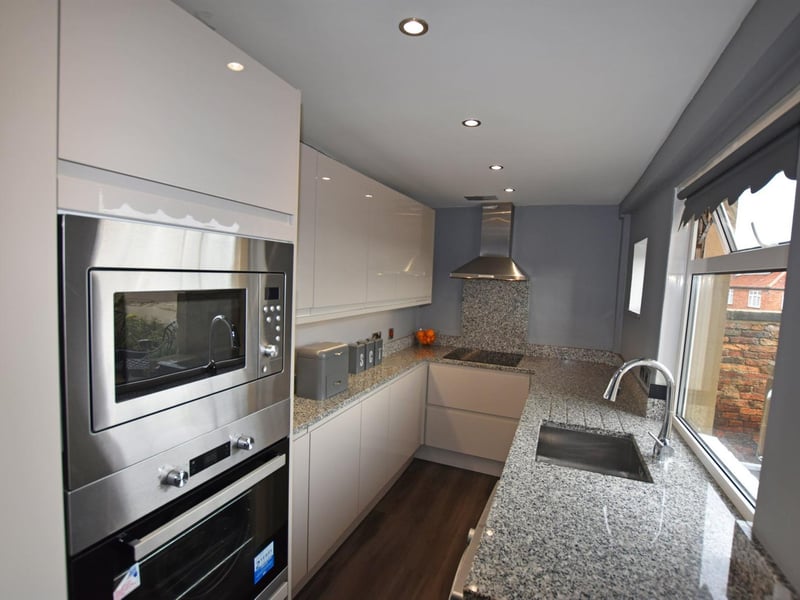 A modern kitchen again has a window with a great outlook.
