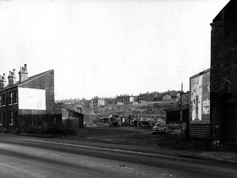 November 1967 and this photo is a view on Elland Road showing a fenced off area with parked cars and looking towards a refuse tip.