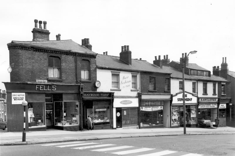 Looking across Beeston Road to parade of shops in July 1964 featuring Haywood, watchmakers & jewellers, Jessie Leech Hair Fashions, Rawcliffe's Upholstery, Jesse Stephenson grocer's and Fred's Fish & Chips.