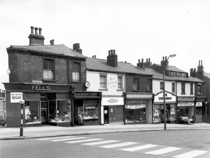 Looking across Beeston Road to parade of shops in July 1964 featuring Haywood, watchmakers & jewellers, Jessie Leech Hair Fashions, Rawcliffe's Upholstery, Jesse Stephenson grocer's and Fred's Fish & Chips.