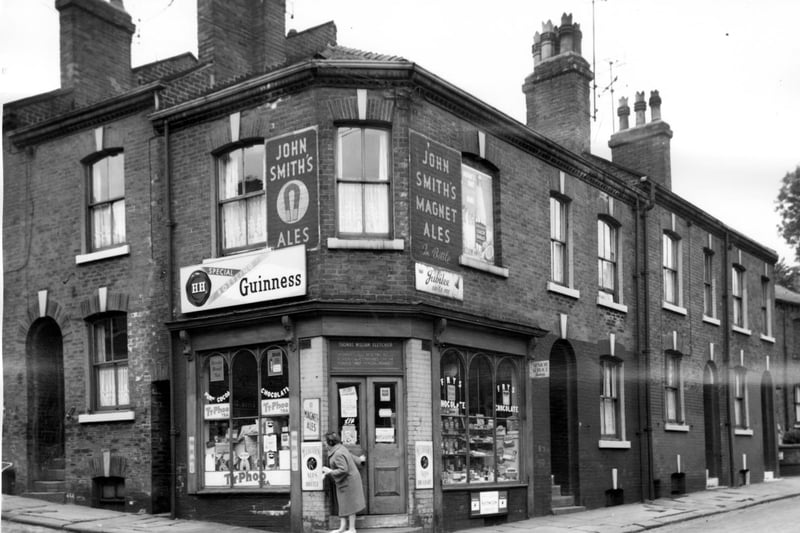Malvern Road pictured at its junction with Algeria Street in July 1964. The corner shop has the name Thomas William Fletcher over the door and sells groceries, confectionery and is licensed to sell alcohol.