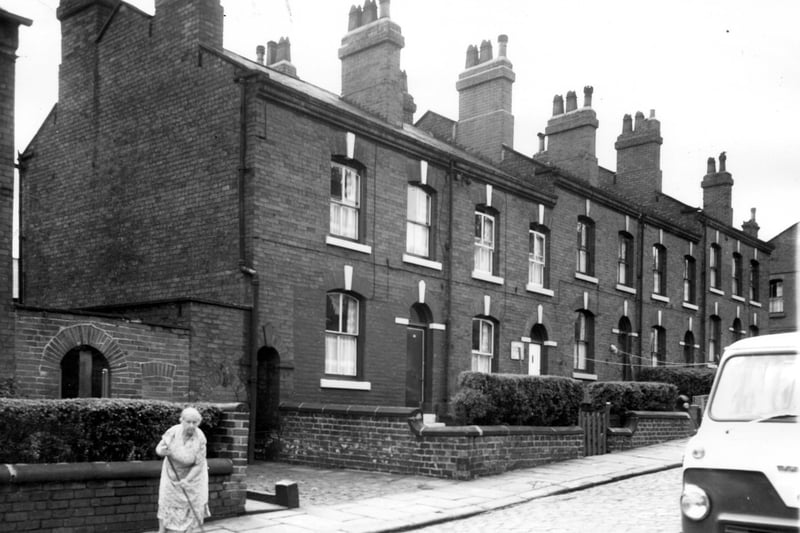 A view of back-to-back terraced houses constructed in red brick on Algeria Street in July 1964.
