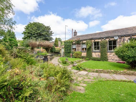 Greenery surrounds this attractive property that is currently for sale.