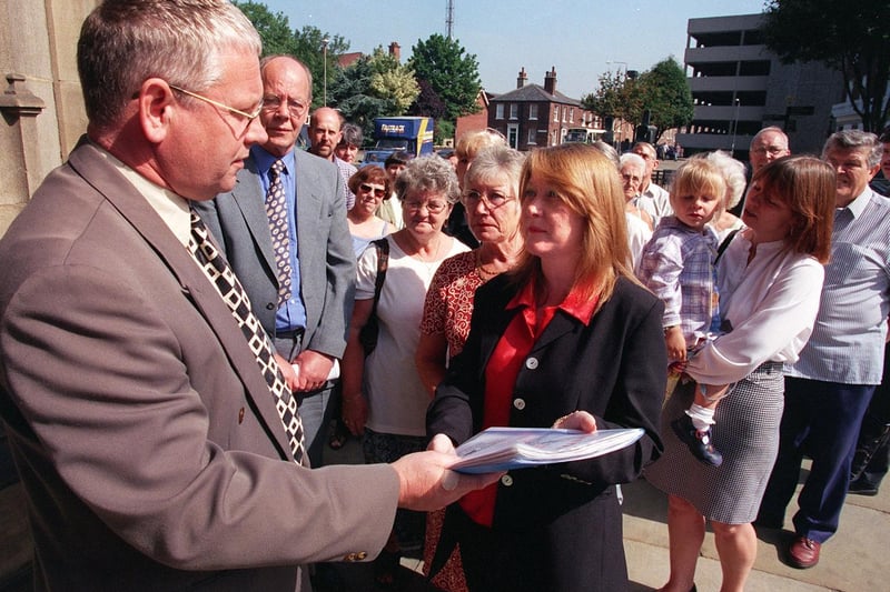 Lynne Nicholson hands over a petition to Coun Phil McNeill, chairman of Wakefield Council Planning Regulatory Board, against a planned bail hostel in the Dewsbury Road area.