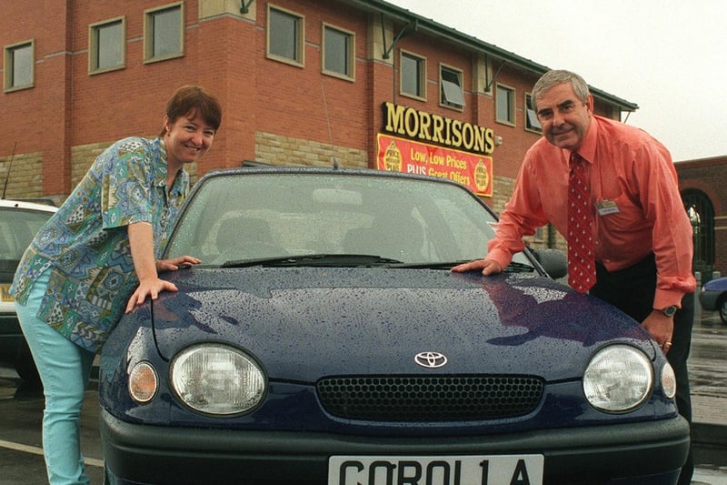 Michelle Creighton is pictured receiving the car she won in a Morrisons supermarket raffle in August 1999. She is pictured with Tony Bolton, general manager of the Dewsbury Road store.