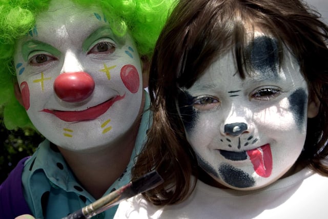 Maisy Dutton from Tingley gets her face painted by Bobbles the clown at Morley Carnival in June 2002.