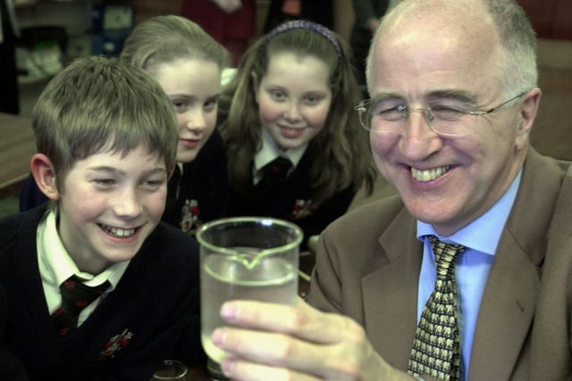 Foreign Office Minister Denis MacShane looks at a sample of pond water with students in the science department at Bruntcliffe High School in March 2002.