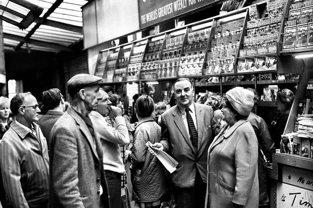 Sid Smith at his busy newspaper stall in the Market Arcade, better known as the Little Arcade, Wigan in September 1971