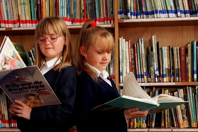 Local firms were having to sponsor books at Swarcliffe Primary owing to a lack of school funds. Pictured are pupils Kelly Wainwright and Melissa Blackburn enjoying their reading lesson.
